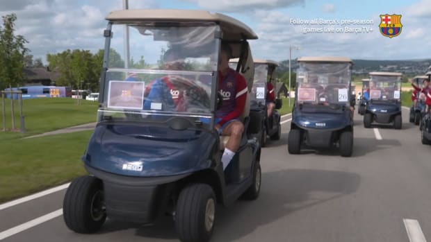 FC Barcelona players drive to training in golf carts